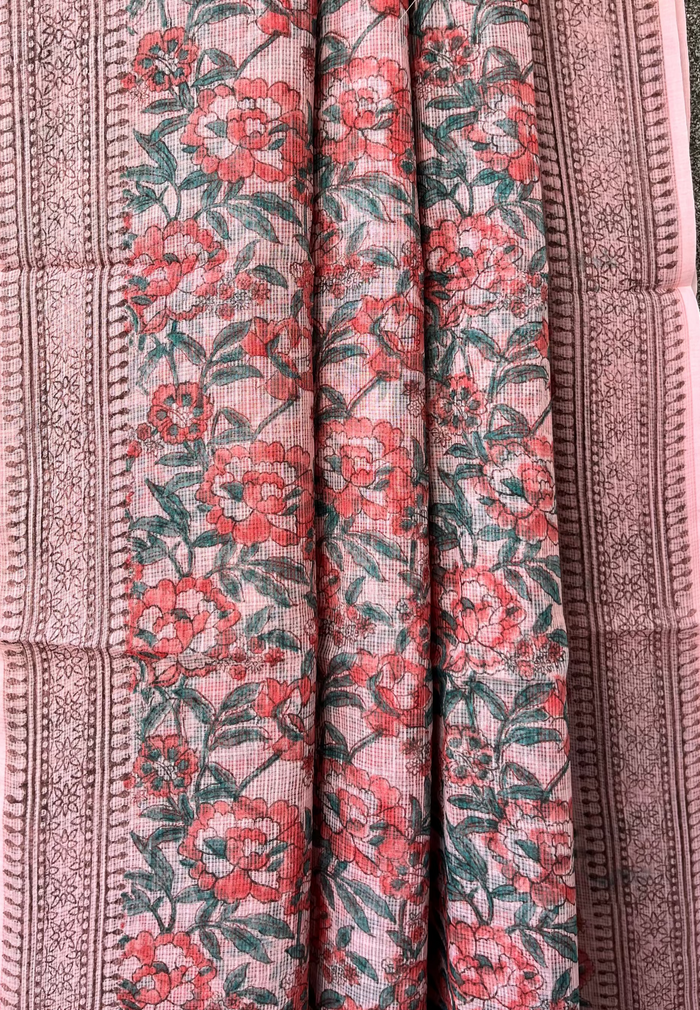 Floral patterned saree with pink and green flower motifs on a textured background